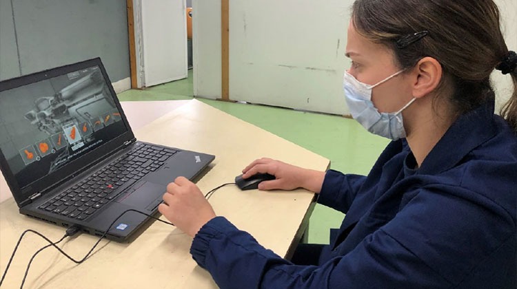Woman using laptop for 3D training visualization
